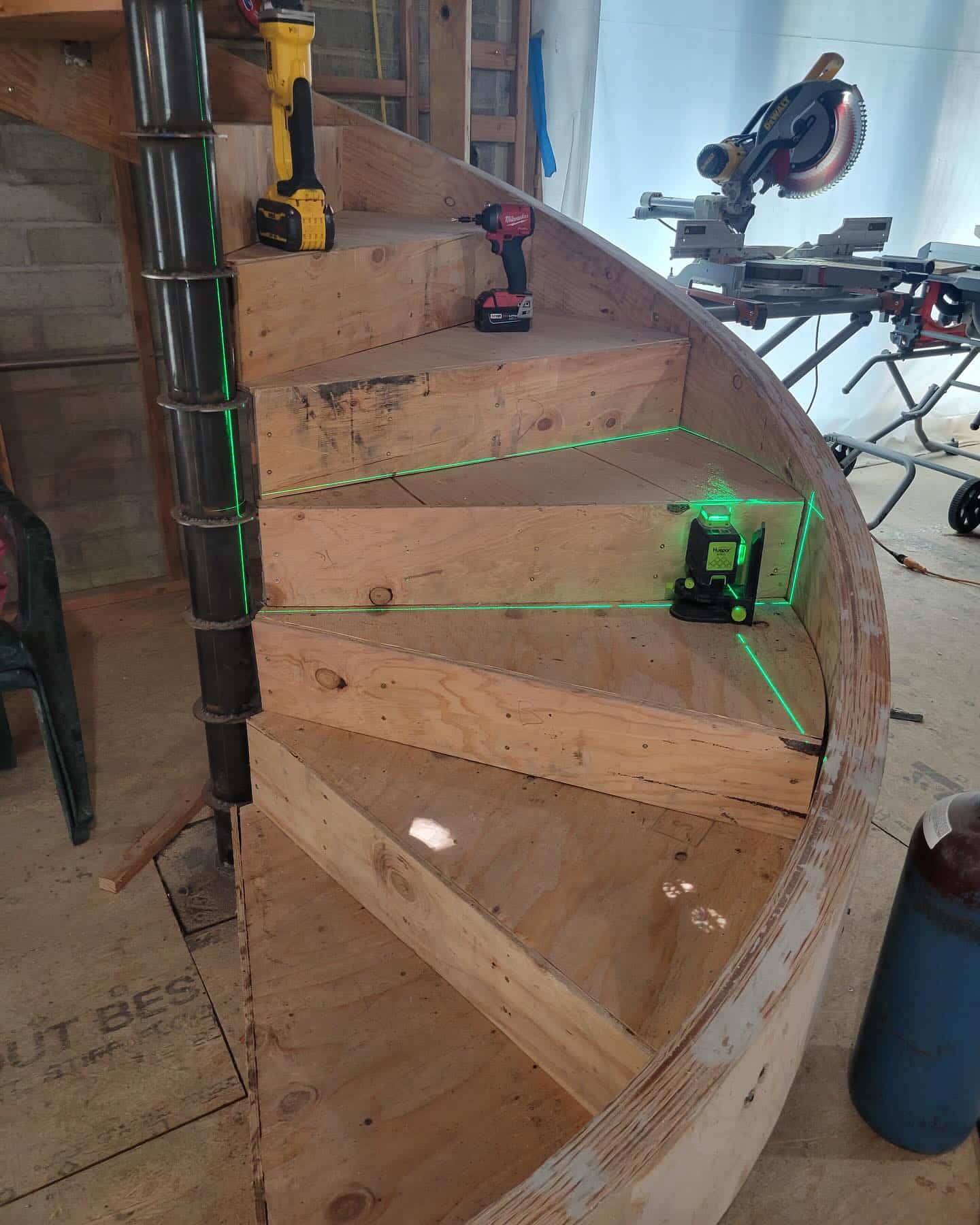 Plywood panels being applied over the metal treads for leveling and prep.