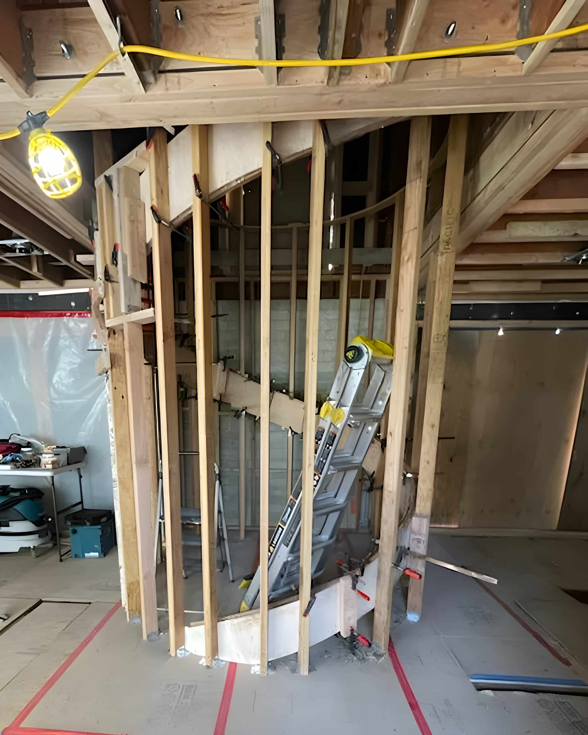 Vertical framing studs arranged in a circular layout to guide the spiral stair’s shape.