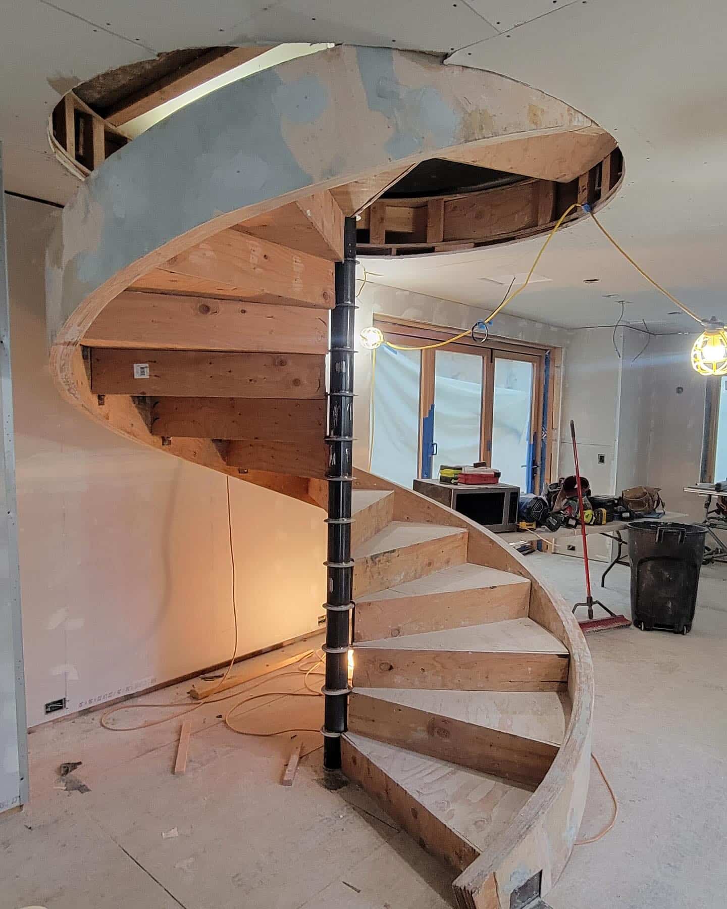 Surface filler applied to cover bolts and seams on the spiral stair stringer.