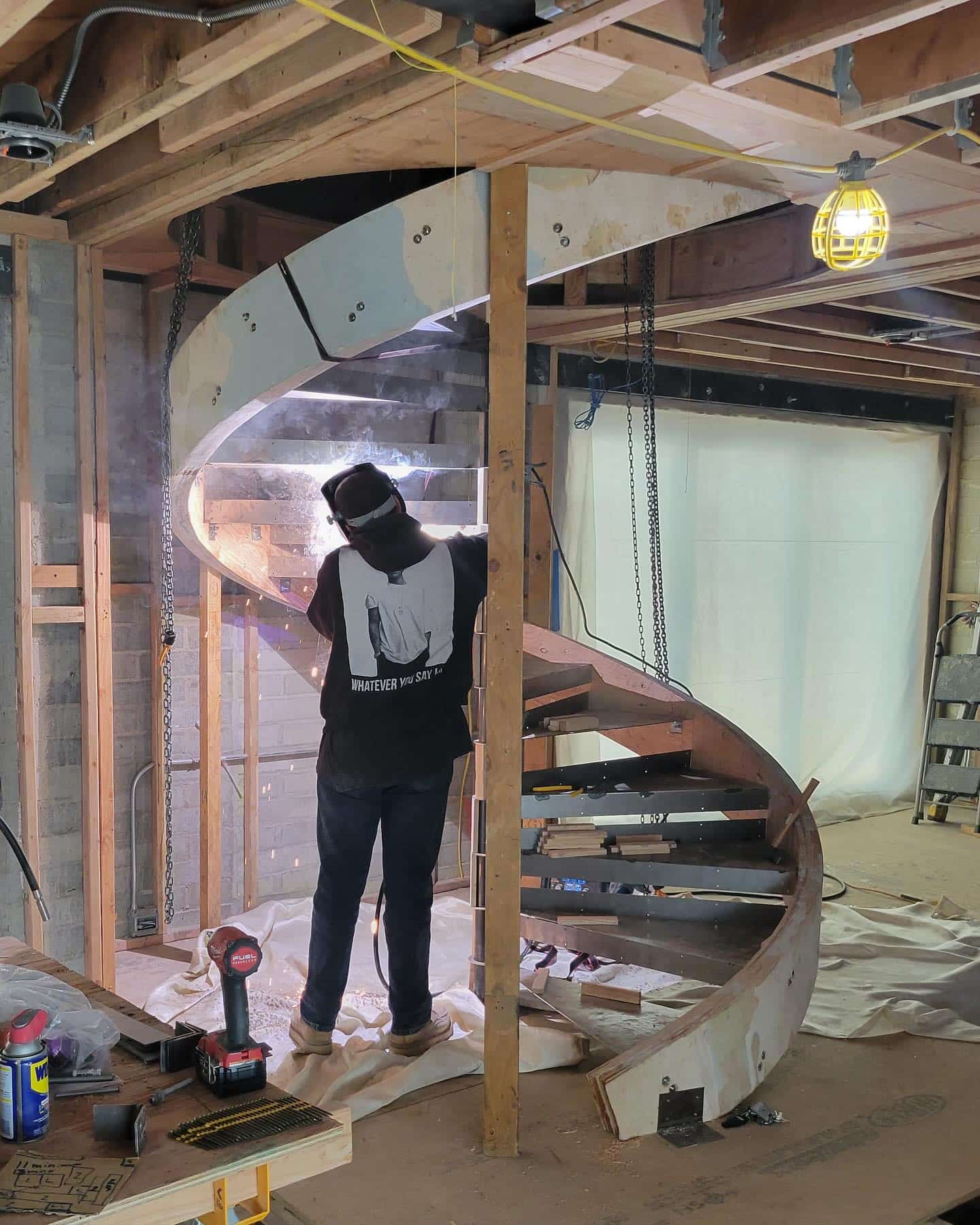 Laminated wood stringer in place with metal treads and central steel column installed.